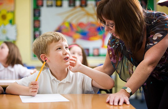 A pupil and a teacher working